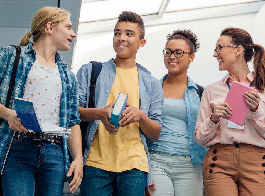 Four college students with books at the ready